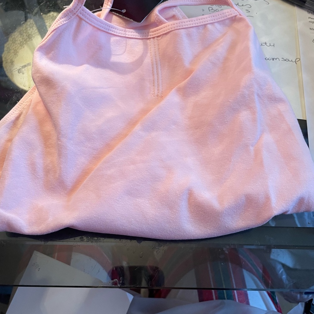 Pink spaghetti strap leotard.  Brand new with tags never used.